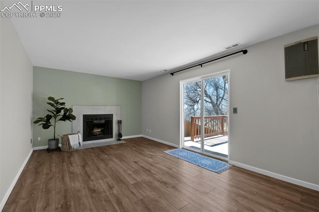 Large family room with fireplace and walk-out to deck and yard. 