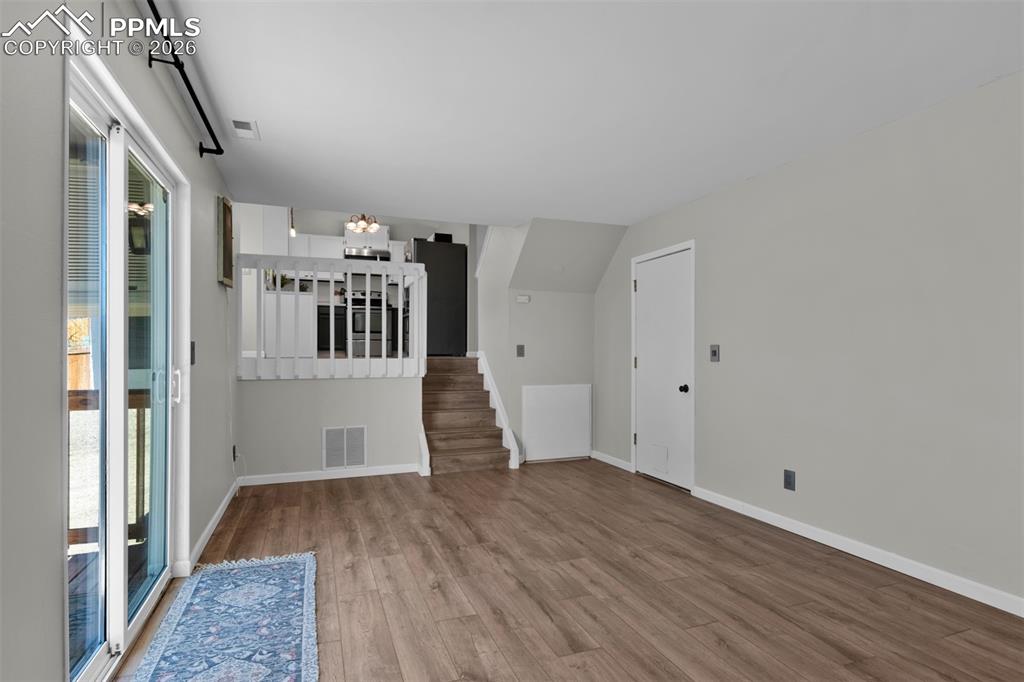Opposite view of the Family Room open to the dining and kitchen. Access to the garage is shown on the right. 