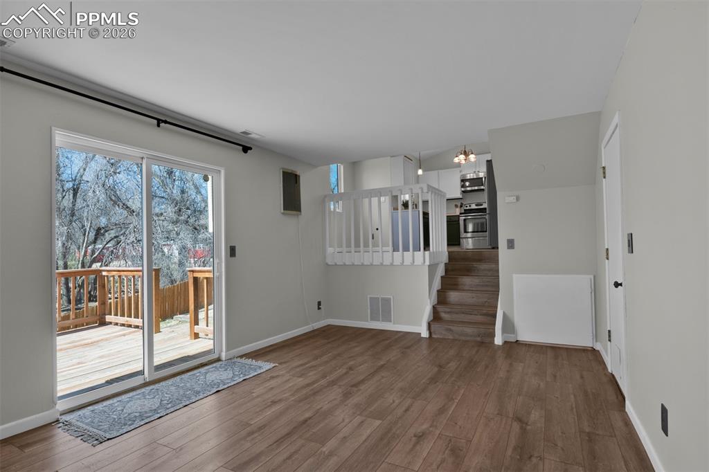 Opposite view of the Family Room open to the dining and kitchen. Access to the garage is shown on the right. 