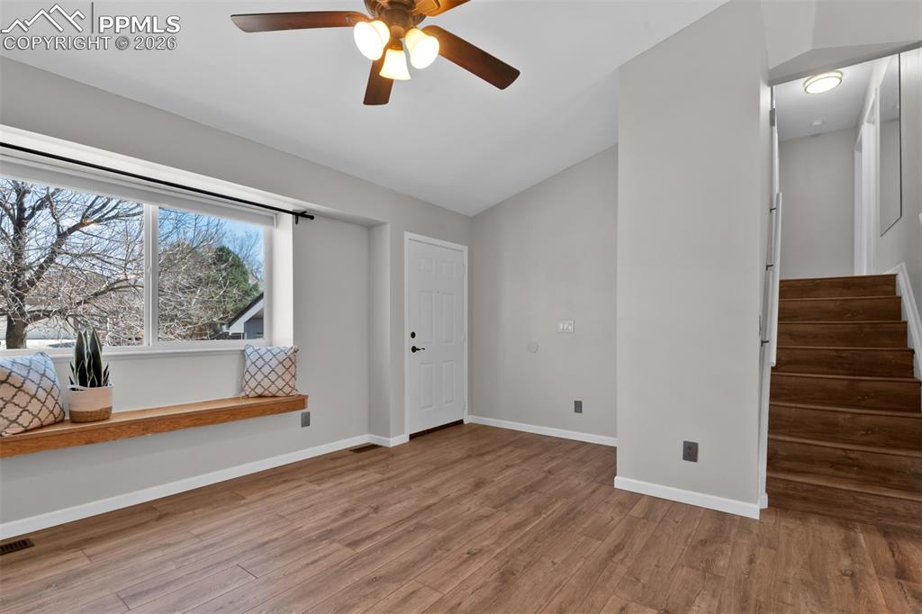 Living room showing entry and stairs to upper level.