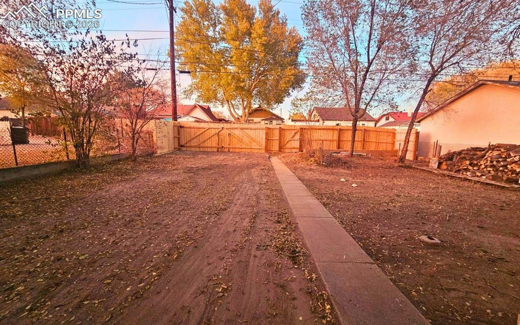 Large yard and cedar fencing with swing door, and man door