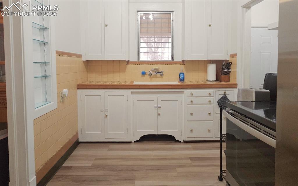 View of Kitchen facing window.  Drop zone to the right. 