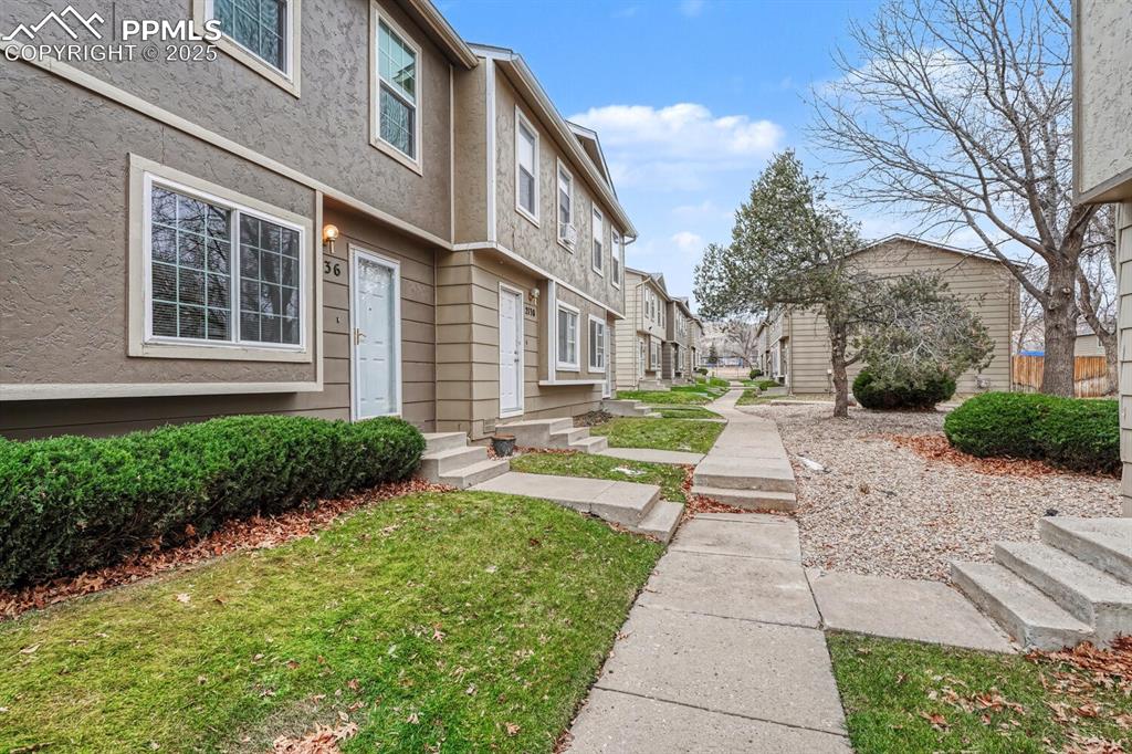 Surrounding community with a residential view and a yard