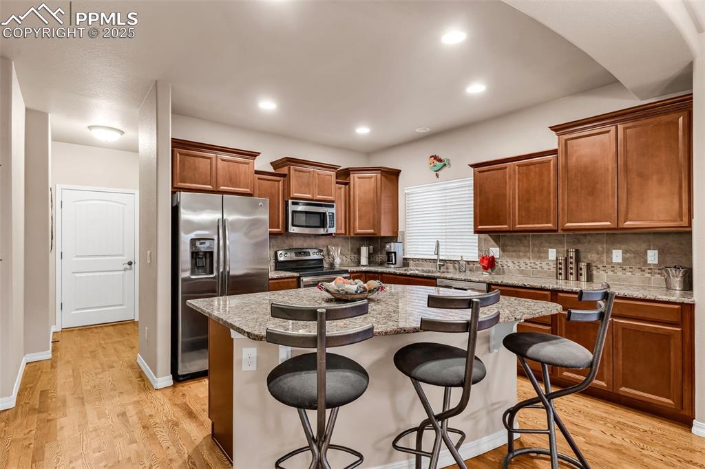 From the kitchen, a spacious hallway leads to the garage and laundry room.