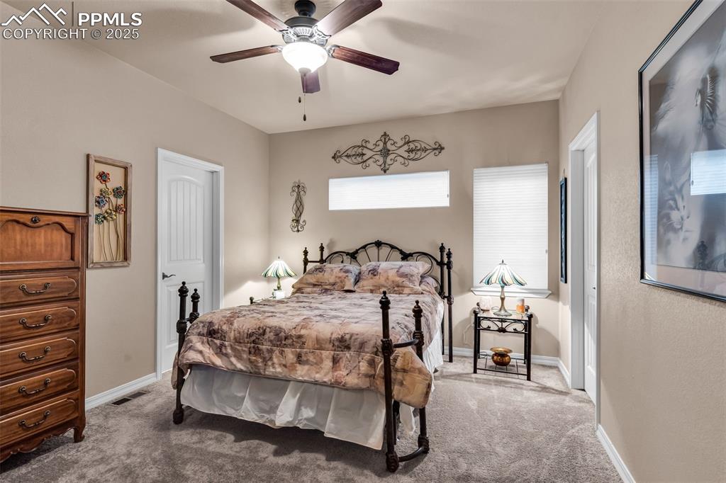 The primary bedroom suite is an oasis of comfort, with plenty of natural light and ceiling fan.