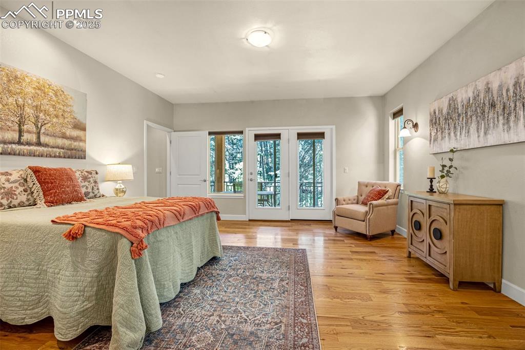 Bedroom with access to outside, light wood-style flooring, baseboards, and recessed lighting