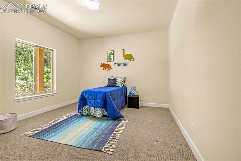 Carpeted bedroom featuring baseboards