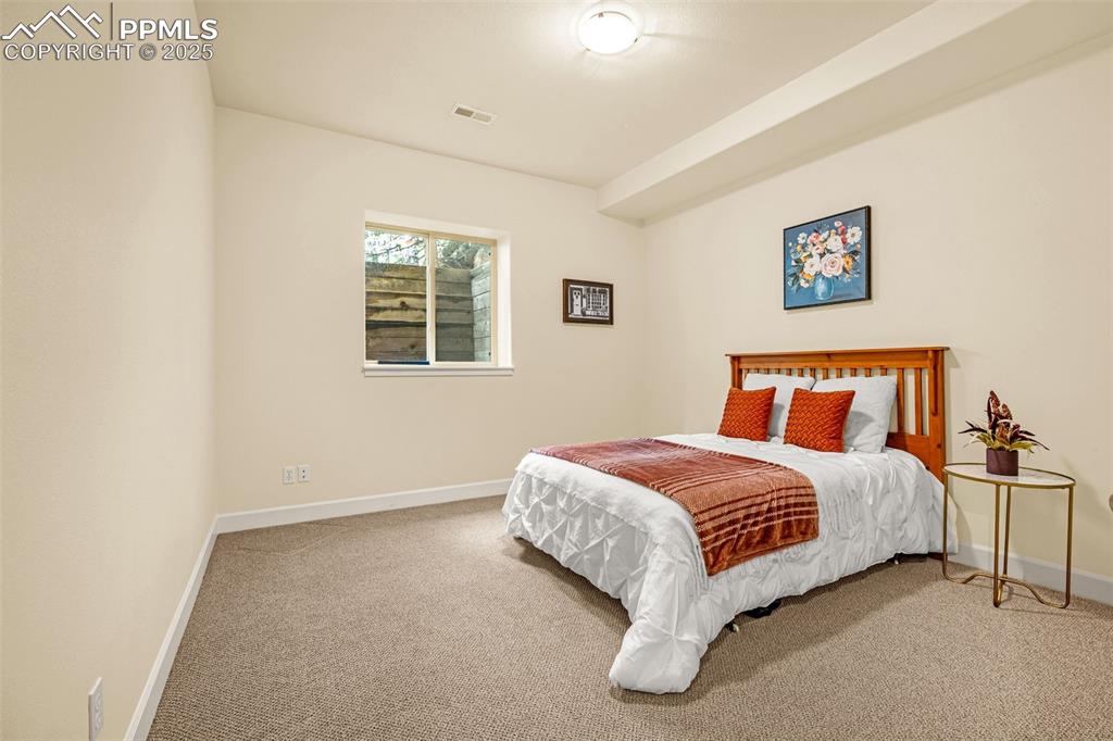 Carpeted bedroom with baseboards