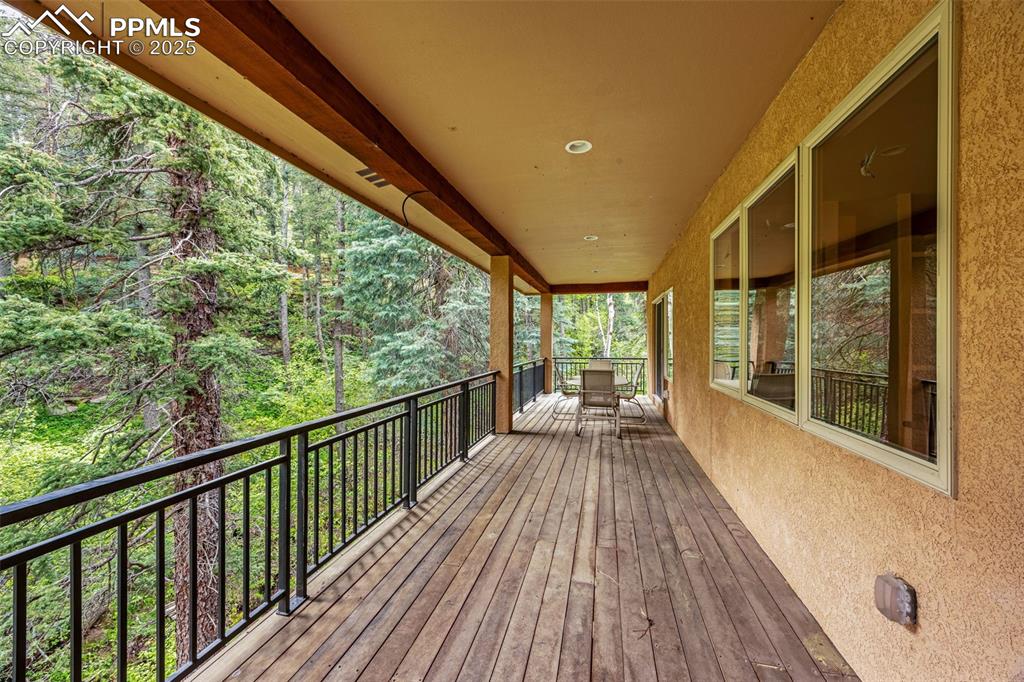 Wooden deck featuring a wooded view