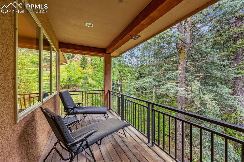 Wooden deck featuring a forest view