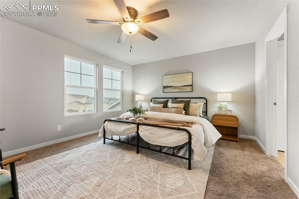 Bedroom featuring light carpet and a ceiling fan