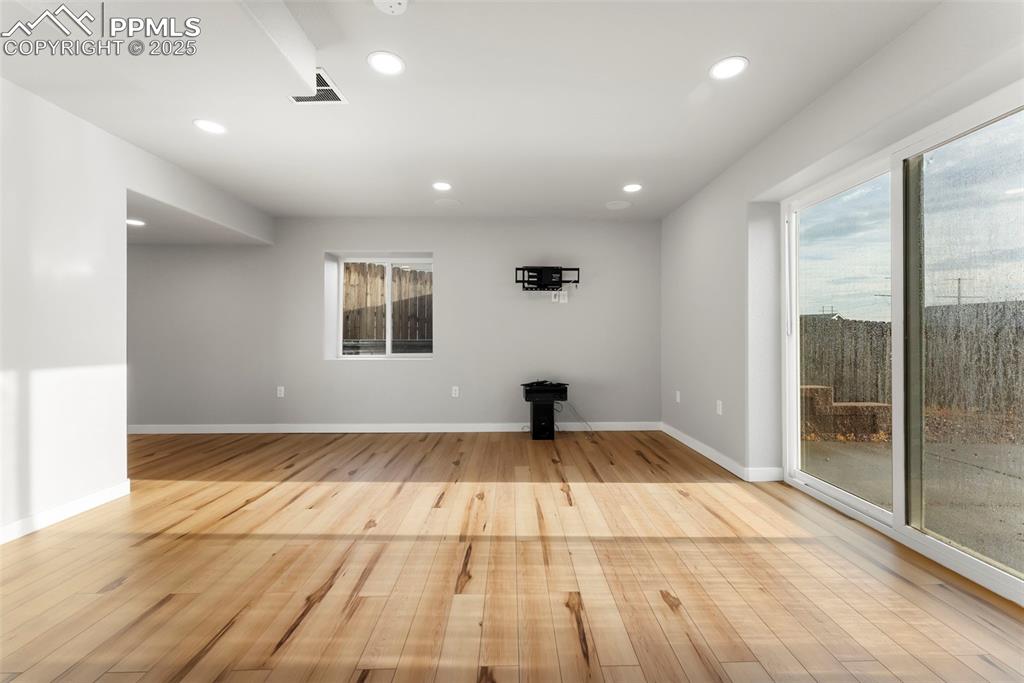 Unfurnished living room featuring recessed lighting, light wood-style flooring, and plenty of natural light