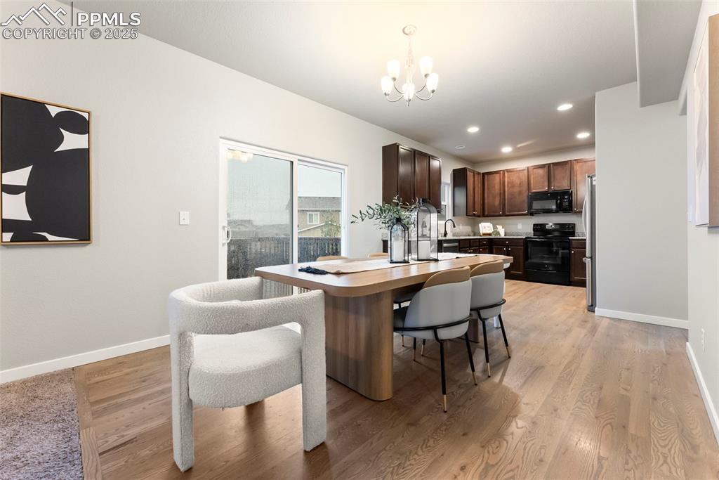 Dining room featuring recessed lighting, light wood-type flooring, and a chandelier