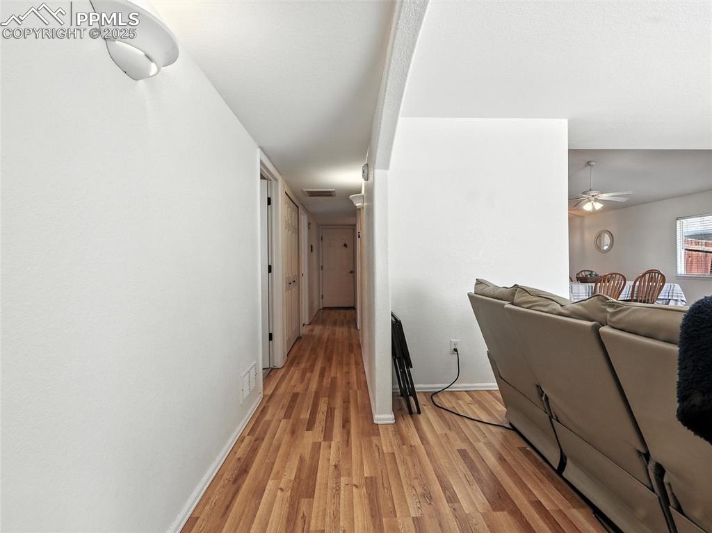 hallway - access to secondary bedrooms, main bath and garage at end of hallway