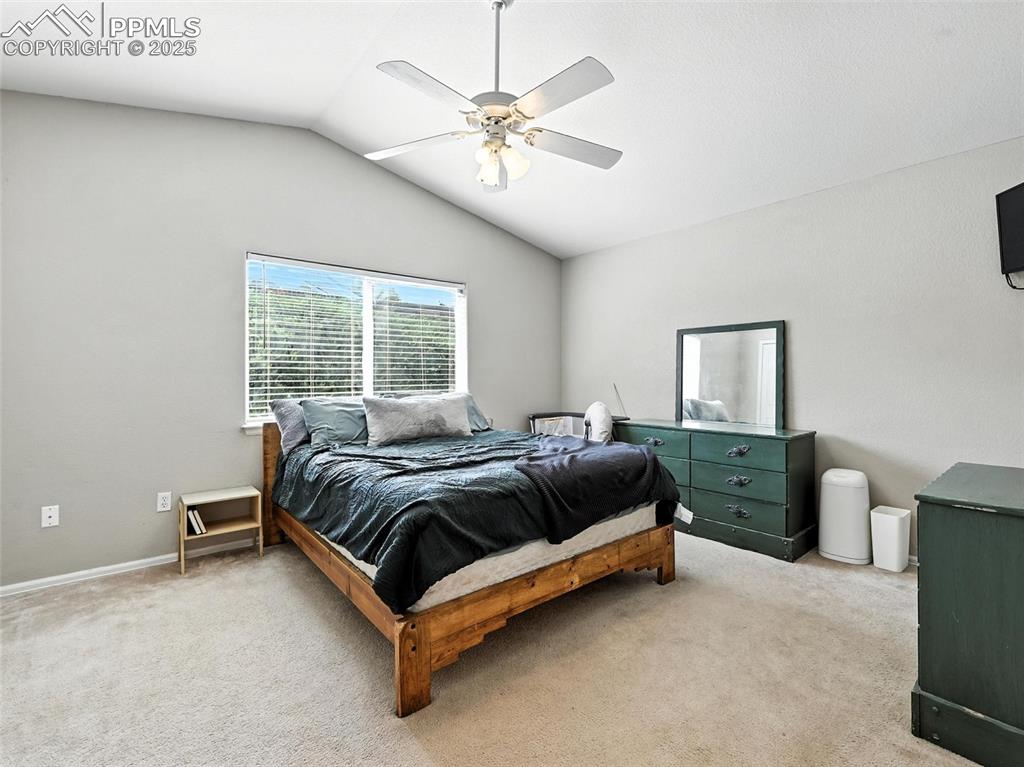 Master bedroom with vaulted ceiling and ceiling fan