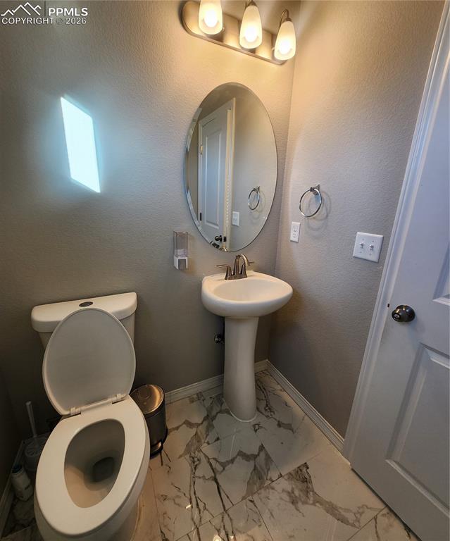 Powder Room located at the main level. With Italian marble flooring.