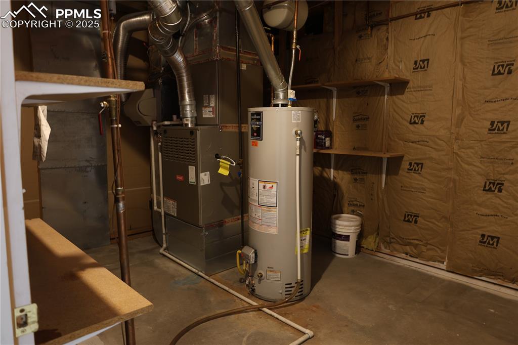Large utility room with water heater and heating unit
