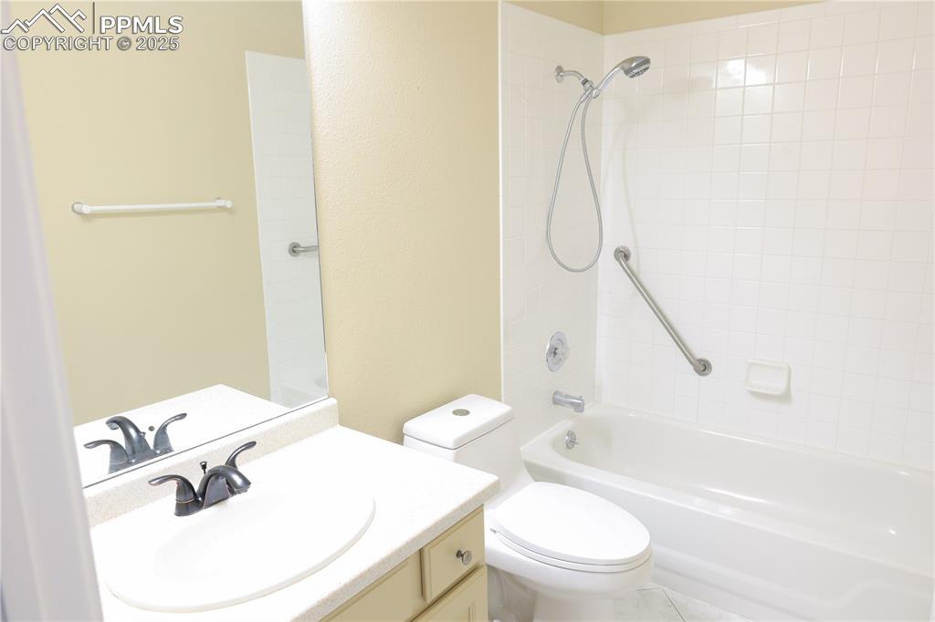 Main level full bath with vanity and bathing tub / shower combination.