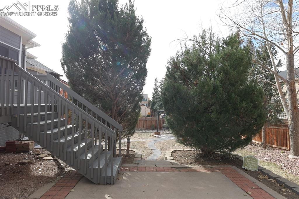 Fenced backyard with stairway