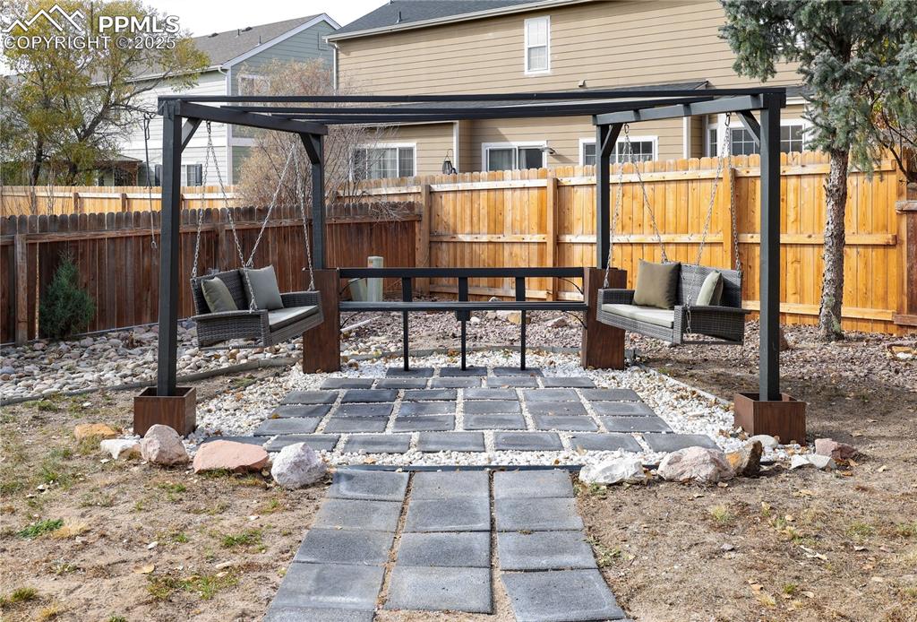 Fenced backyard with a patio