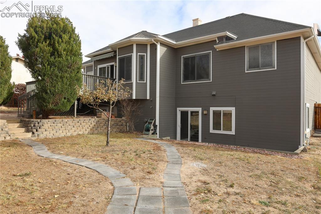 Rear view of property with a chimney