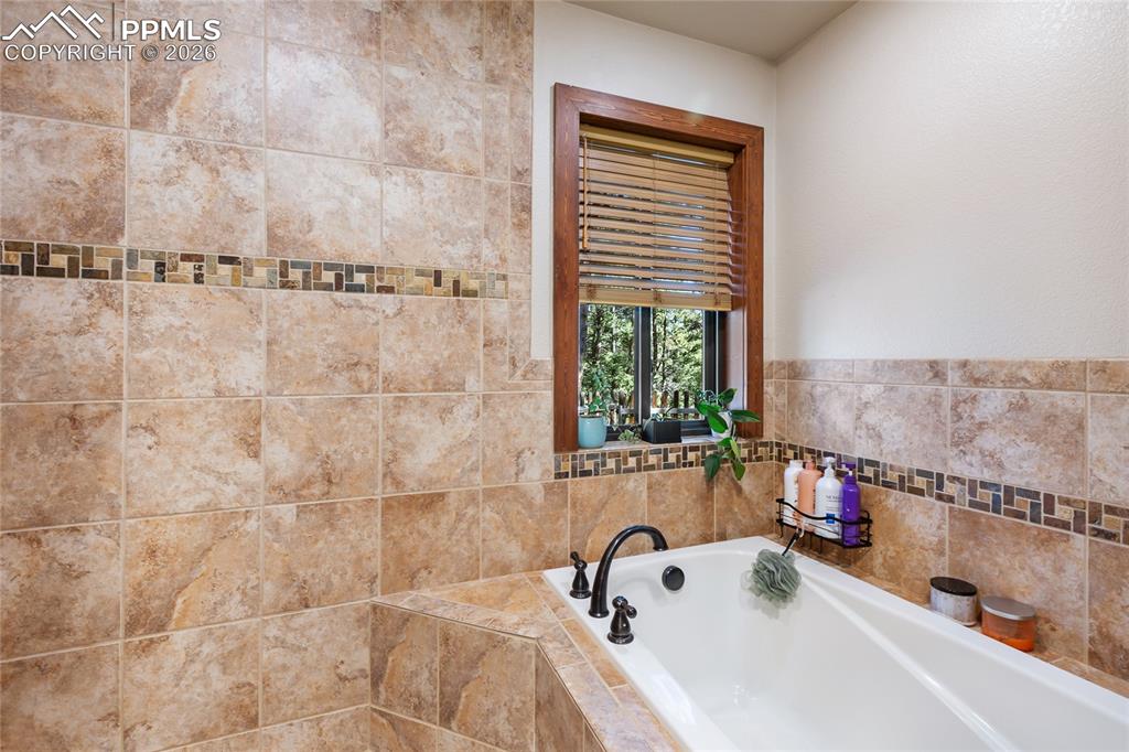 Main level Primary bath featuring a luxurious soaking tub!