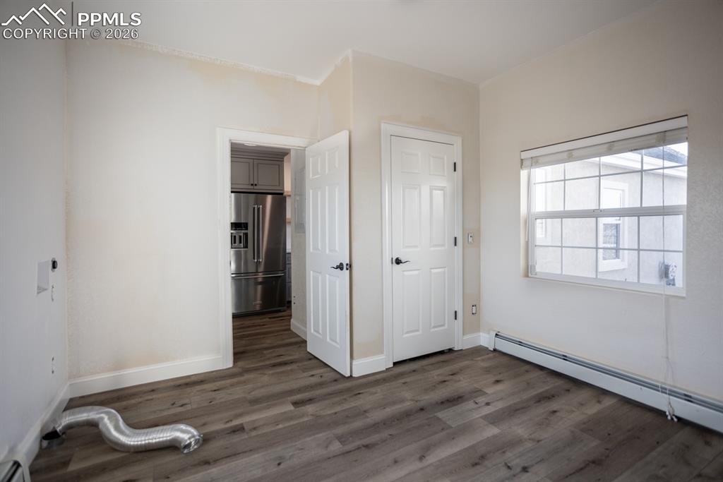 Large laundry area, flexible space for dogs or home office. Painting in progress.