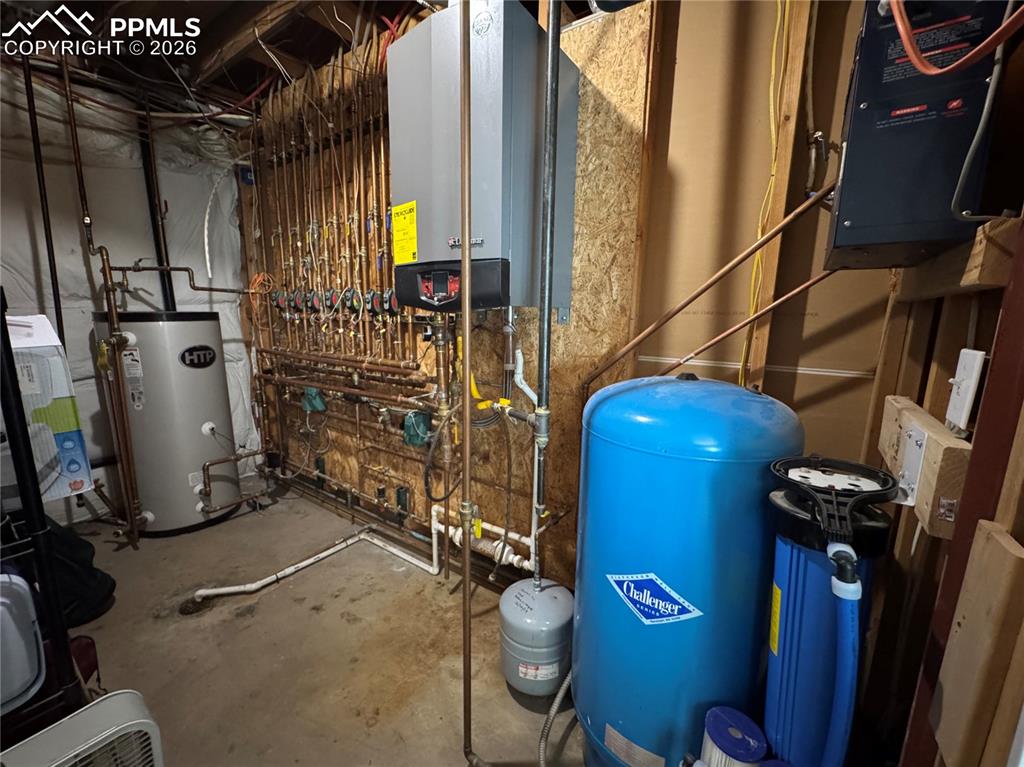 Utility room, with boiler and hot water heater system, whole house filtration, well components. 