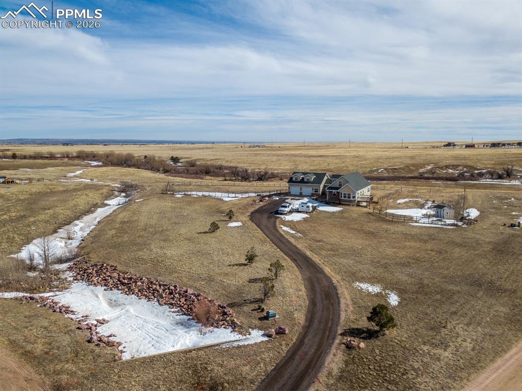 Birds eye view of property featuring a rural view