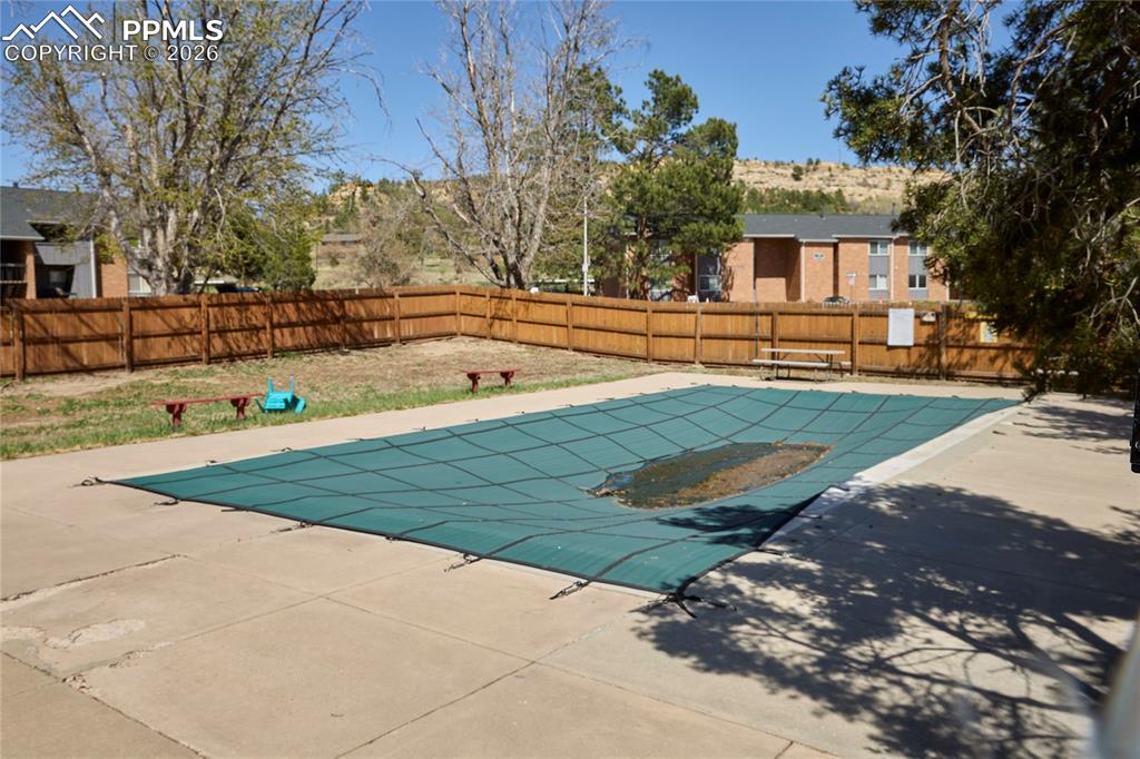 View of swimming pool with a fenced in pool and patio area