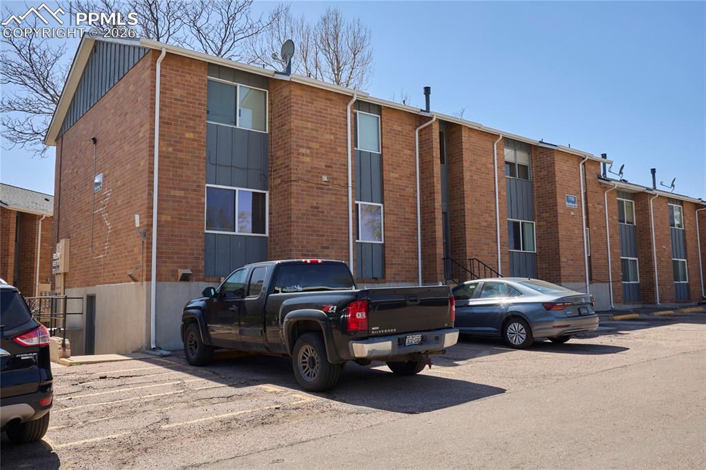 View of property with uncovered parking