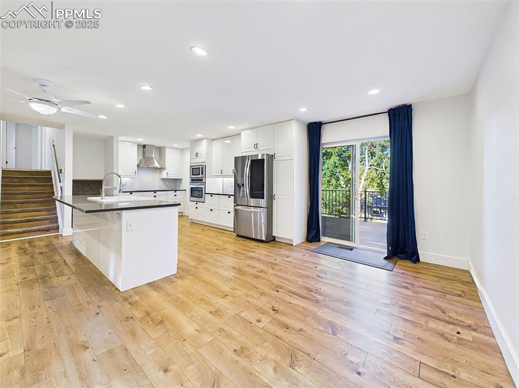 Bright dining nook with sliding glass doors to the deck, recessed lighting, and room for a large table.