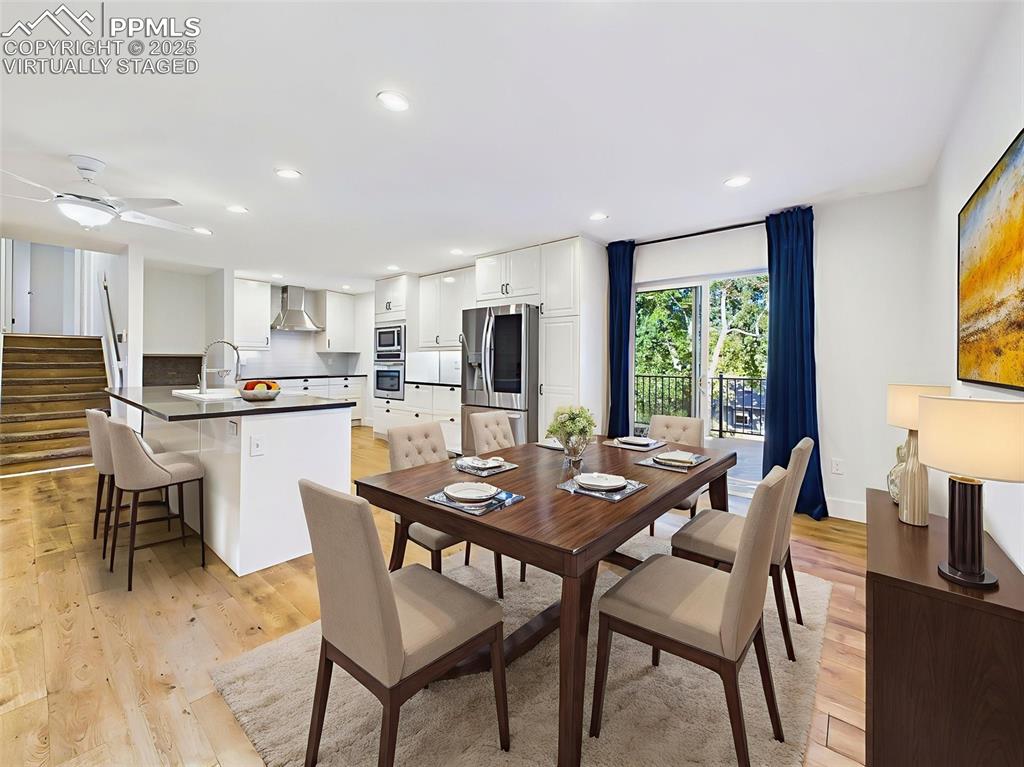 Virtually staged to show a stylish dining setup, this area connects seamlessly to the kitchen and deck—ideal for indoor-outdoor entertaining.