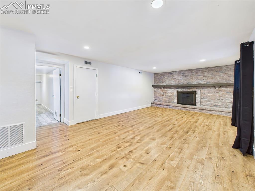 Bright and open lower-level space, perfect for relaxing or gathering, with access to additional rooms and a clean, modern look.