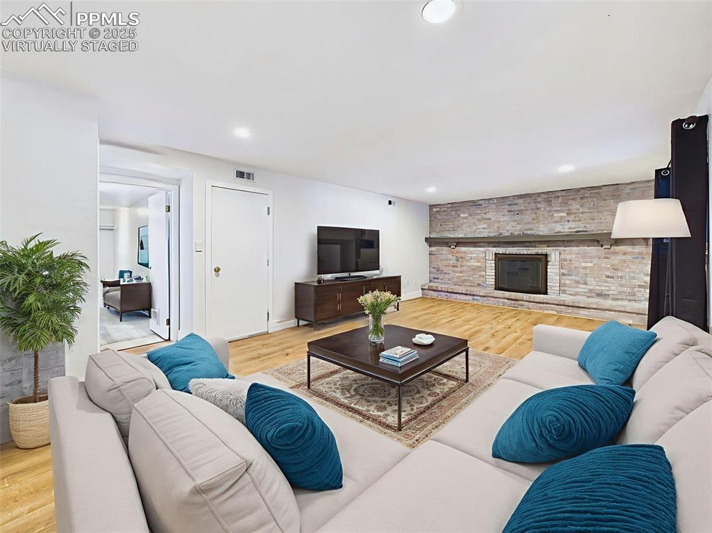 Virtually staged view highlights room for ample seating and a media setup, with access to a flex space through double doors.