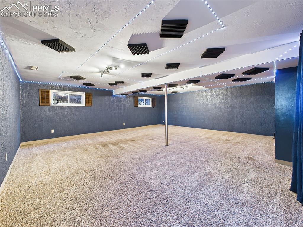 Expansive finished basement with custom ceiling design, LED lighting, and plush carpet—ready for your home theater, gym, or hobby area.
