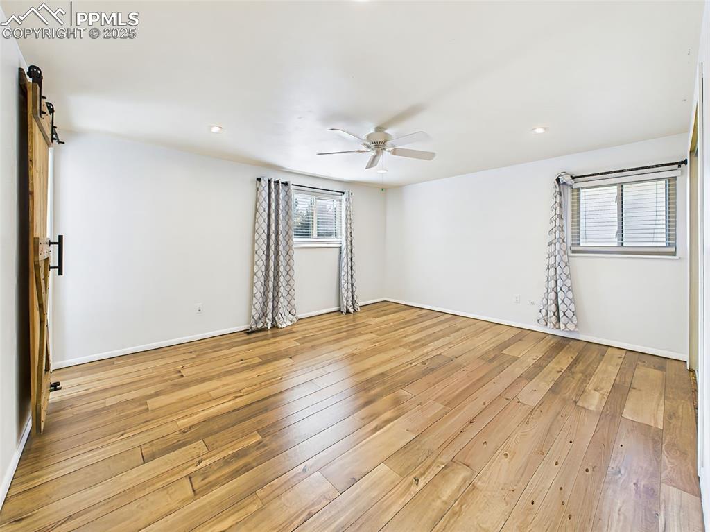 Comfortable bedroom with neutral carpet, ceiling fan, and closet storage—ready for personalization.