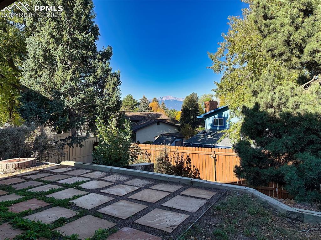 Enjoy a glimpse of mountain views from your private backyard—surrounded by mature trees and neighborhood charm.