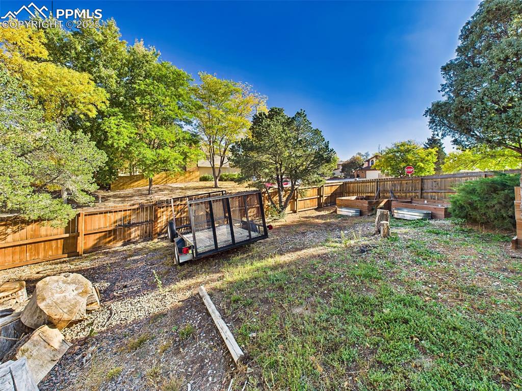 Corner lot offers extra privacy and usability with side yard access, planter boxes, and a large gate.