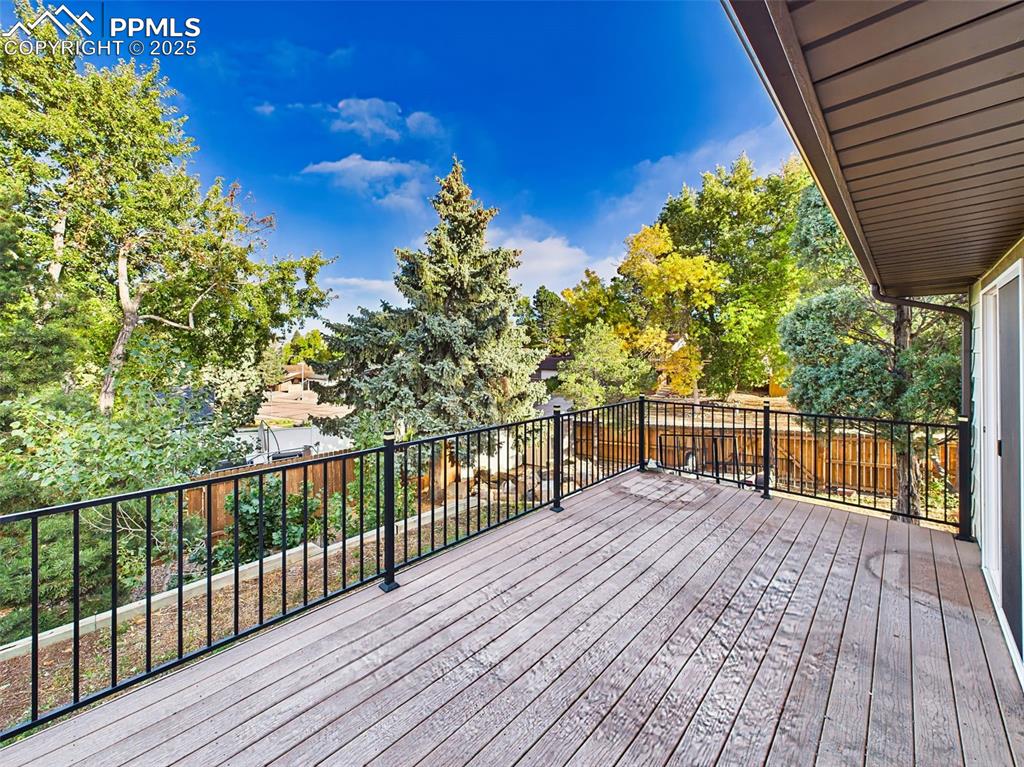 Durable composite deck with metal railings and sliding glass door access to the main living area—ideal for grilling or morning coffee.