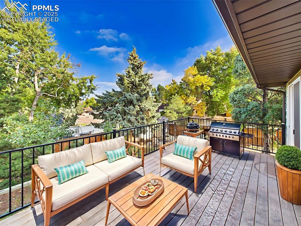 Virtually staged to show a cozy outdoor lounge setup, this elevated deck is perfect for entertaining or soaking up the sun.