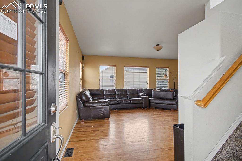 Living room featuring light wood finished floors and stairs