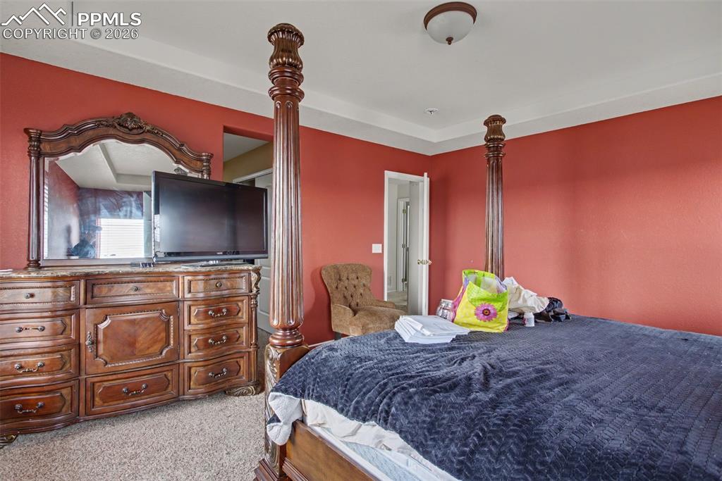 Bedroom featuring light colored carpet