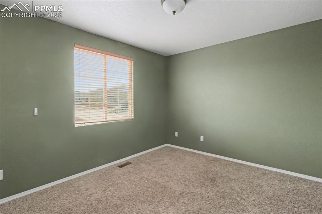 Unfurnished room with baseboards and carpet floors