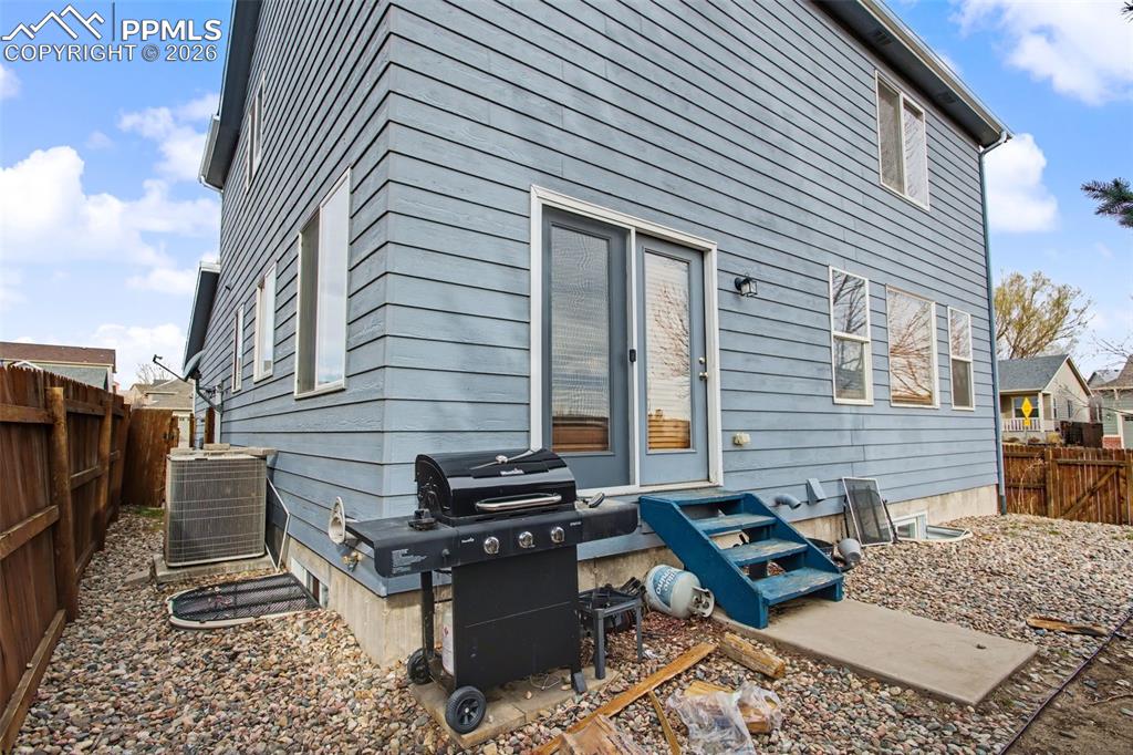 Rear view of property featuring a fenced backyard and a patio