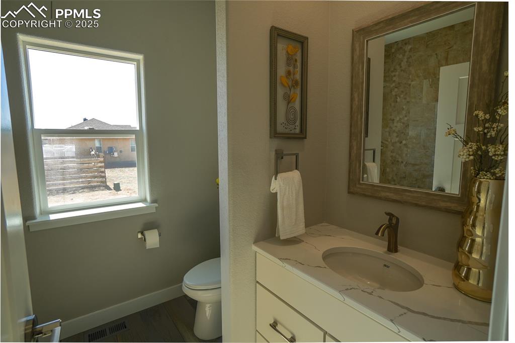 Bathroom featuring vanity and toilet