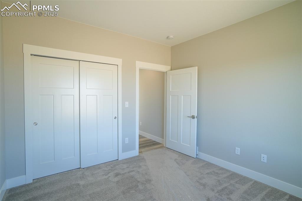 Unfurnished #2 bedroom with light carpet and a closet