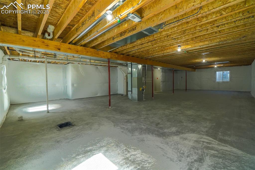 Basement featuring heating unit