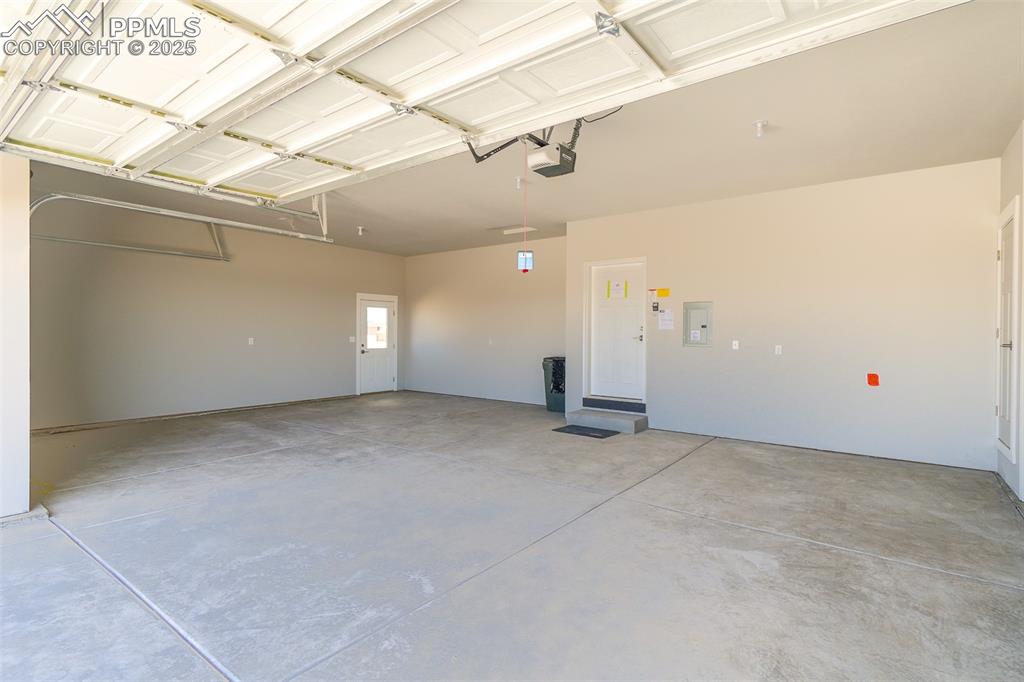 Garage with electric panel and a garage door opener