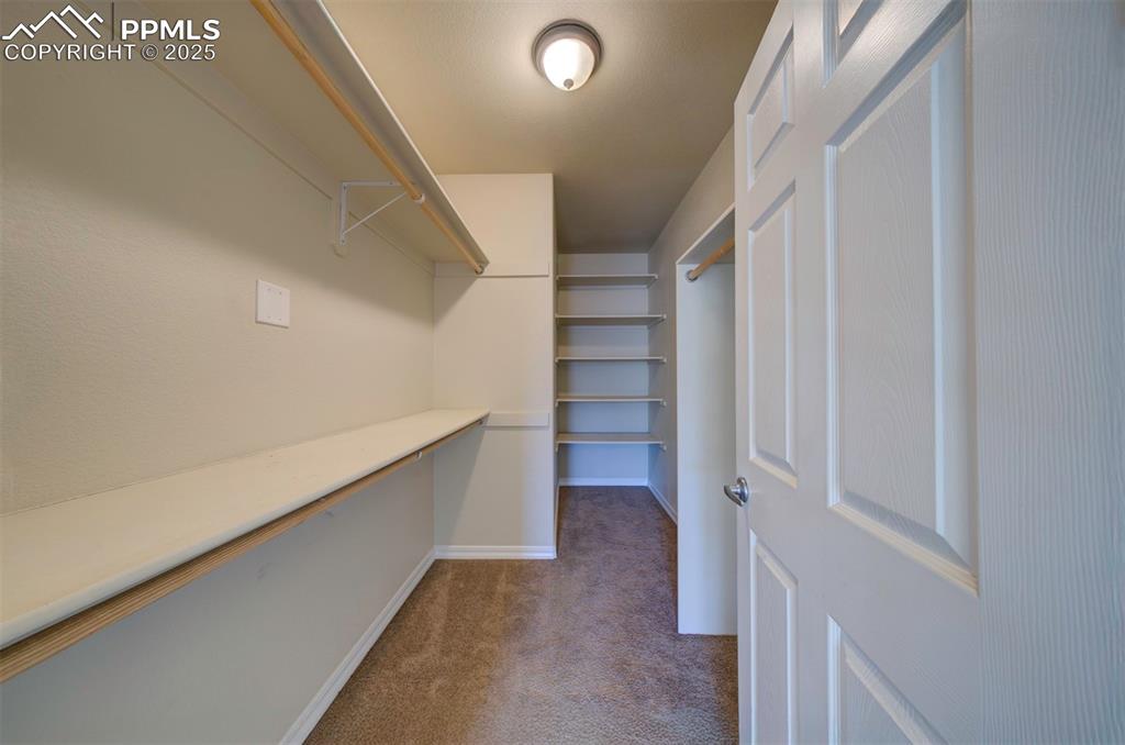 Walk in closet with built in shelves and organizers